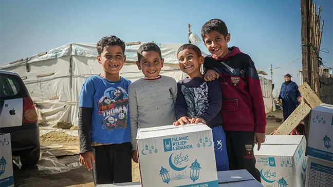 Un groupe de jeunes garçons sourit après avoir reçu des colis alimentaires du ramadan lors de nos distributions dans la Bekaa, à Akkar et à Minieh en février 2026.